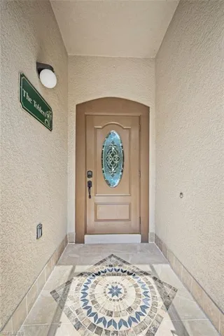 View of exterior entry with stucco siding