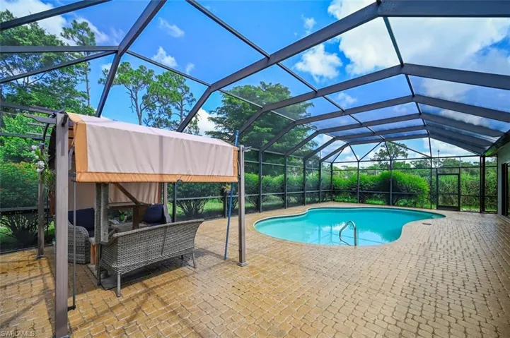 Swimming pool featuring a patio area, an outdoor hangout area, and a lanai