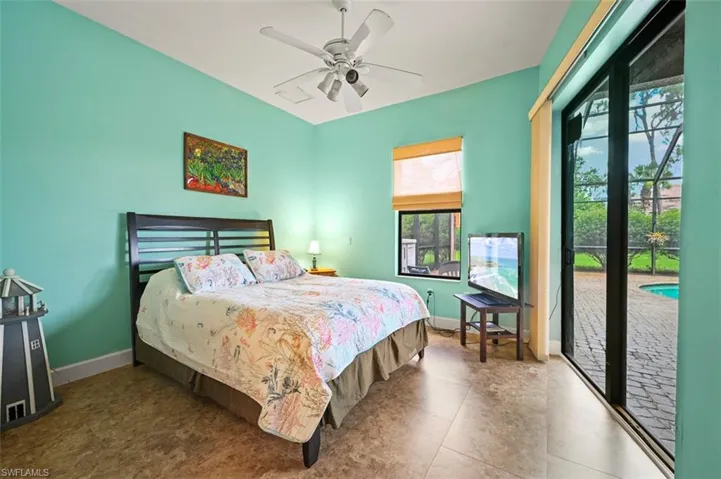 Bedroom featuring access to exterior and a ceiling fan