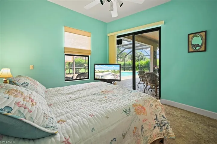Bedroom featuring access to outside, carpet floors, and a ceiling fan