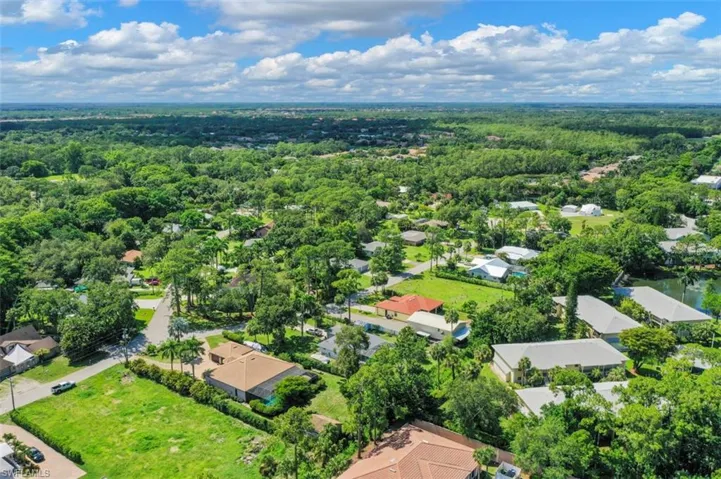 Aerial view of residential area featuring a heavily wooded area