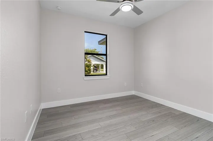 Unfurnished room with light wood-type flooring and ceiling fan