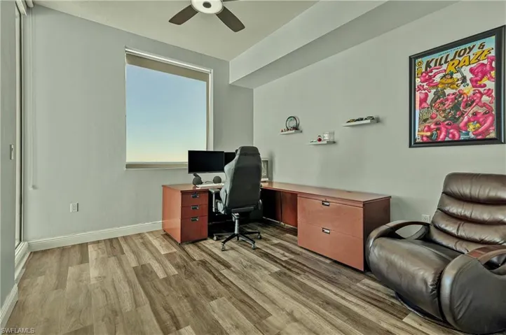 Office with wood finished floors and a ceiling fan
