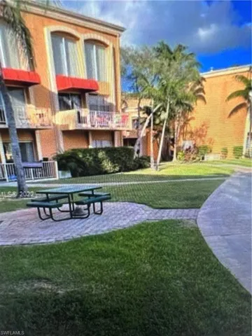 View of property's community featuring a yard and a balcony