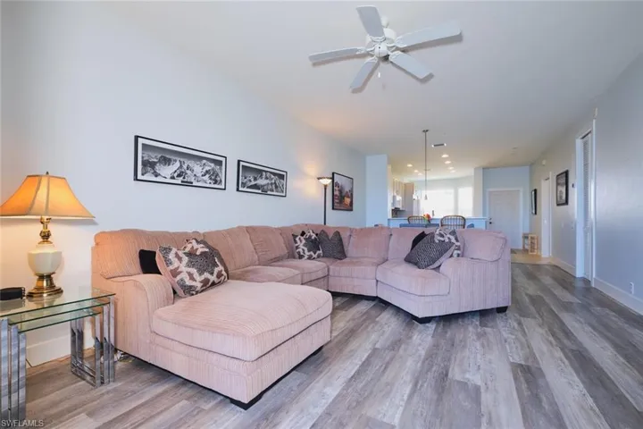 Living room with wood finished floors and a ceiling fan