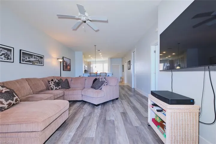Living area with a ceiling fan and wood finished floors