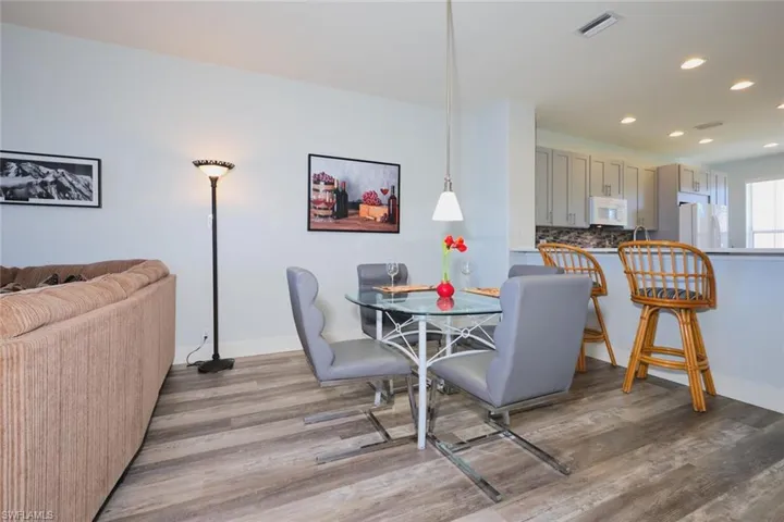 Dining space with recessed lighting and dark wood-style flooring