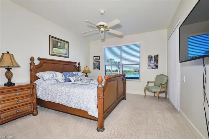 Carpeted bedroom with a closet and a ceiling fan
