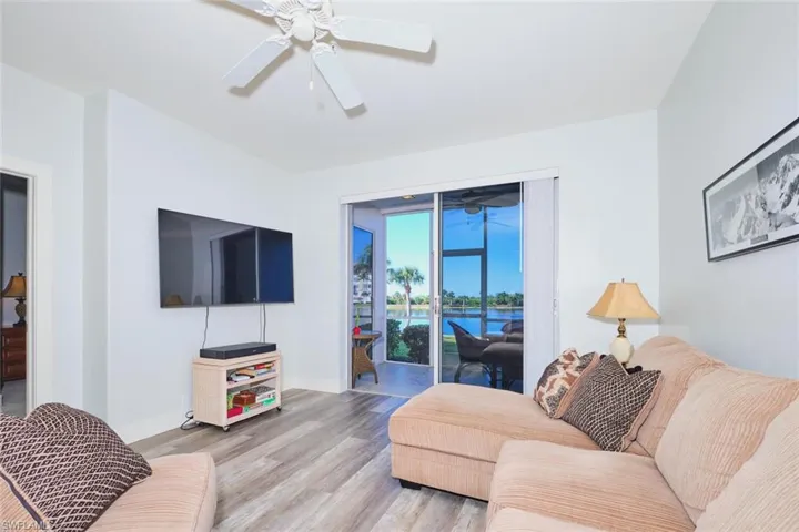 Living area with wood finished floors and a ceiling fan