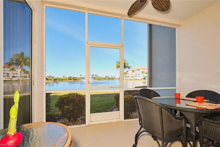 Sunroom featuring a water view and finished concrete floors