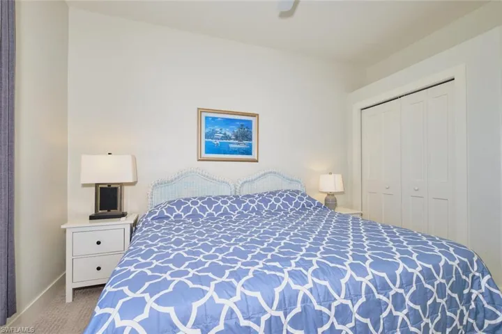 Carpeted bedroom with a closet and ceiling fan