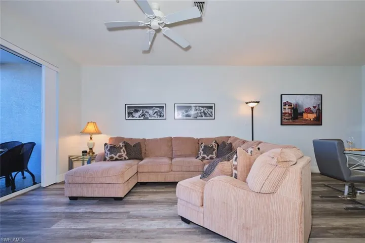 Living area with wood finished floors and a ceiling fan