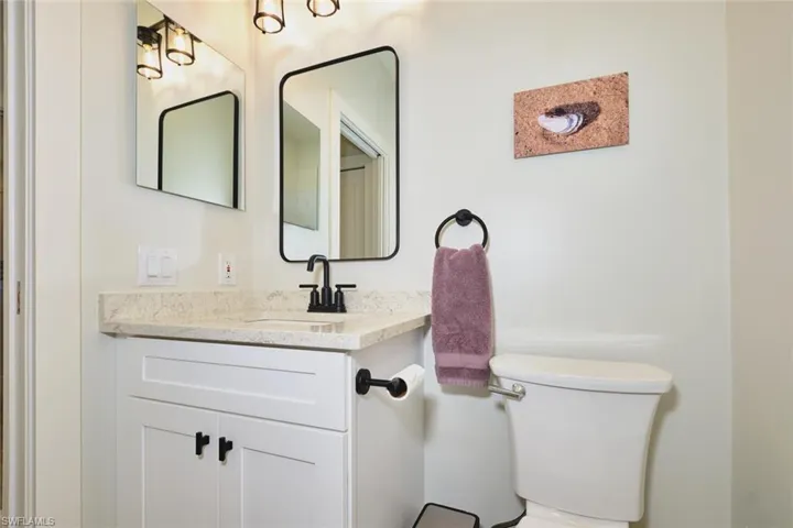 Half bath featuring vanity and toilet