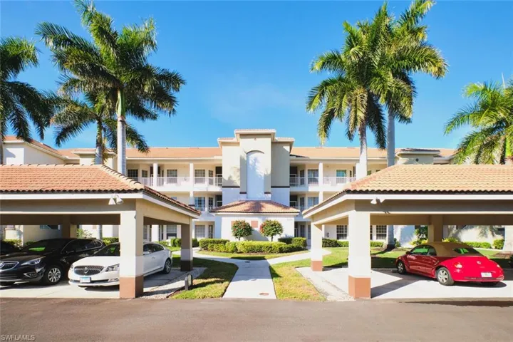 View of property with covered parking