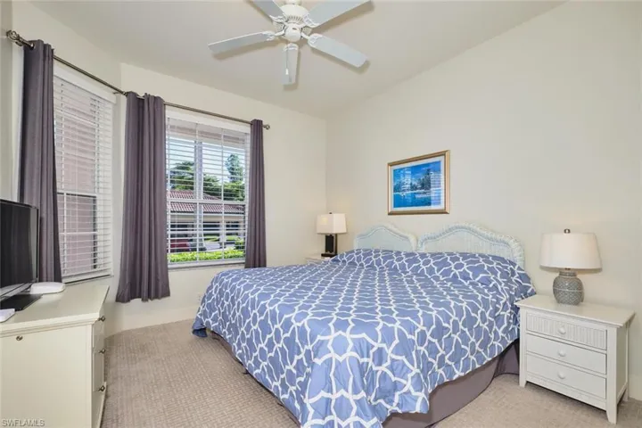 Bedroom featuring light colored carpet and a ceiling fan