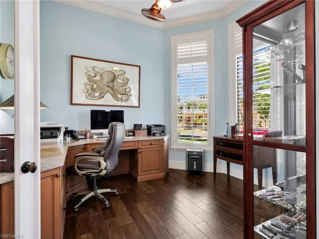 Office featuring dark wood-type flooring and crown molding