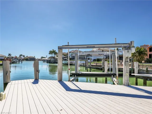 Dock featuring boat lift and a water view
