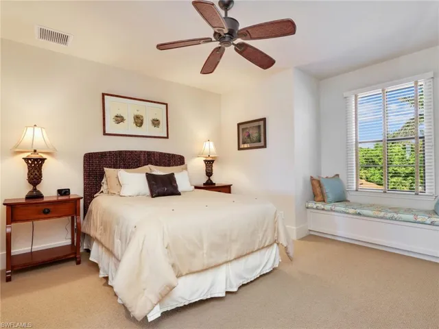 Carpeted bedroom featuring baseboards and ceiling fan