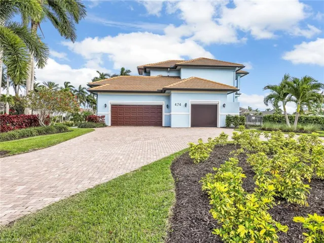 Mediterranean / spanish-style home featuring a garage, decorative driveway, stucco siding, and a tile roof