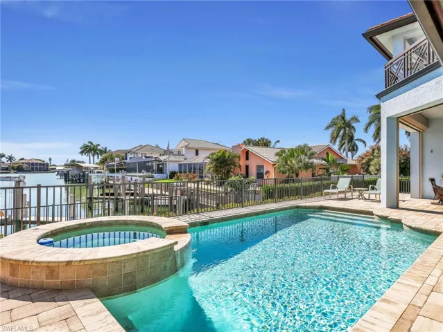 Integrated pool / spa with a patio area, a residential view, and a balcony