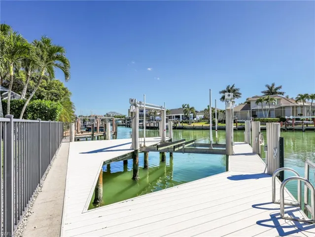 Dock area with a water view and boat lift