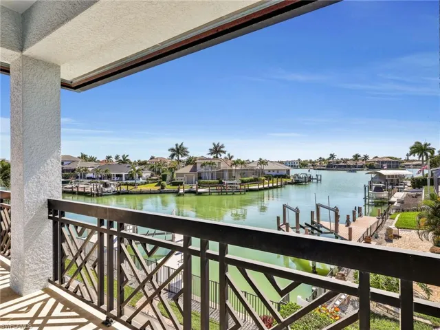 Balcony featuring a residential view, a water view, a dock, and boat lift