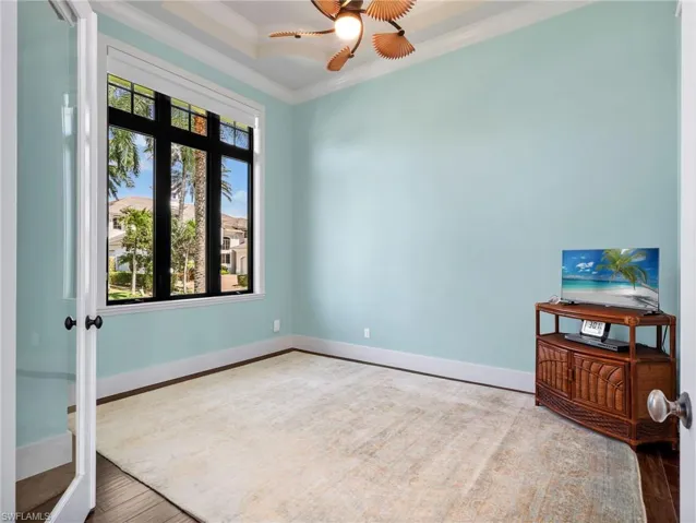 Unfurnished room with wood finished floors, ornamental molding, and a ceiling fan