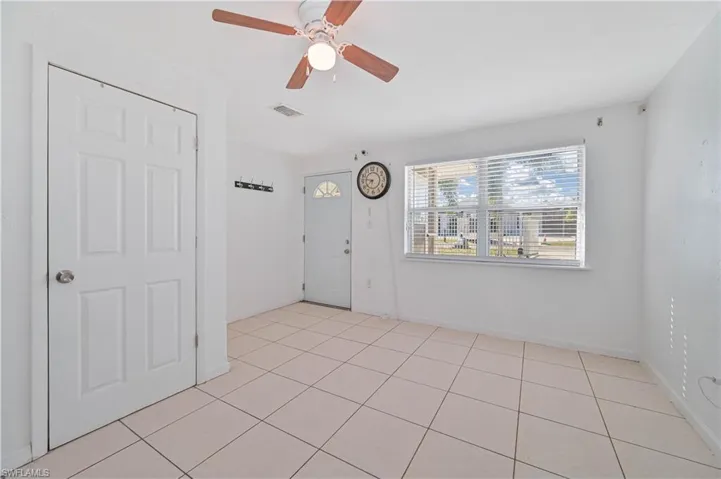Spare room featuring light tile patterned flooring and a ceiling fan