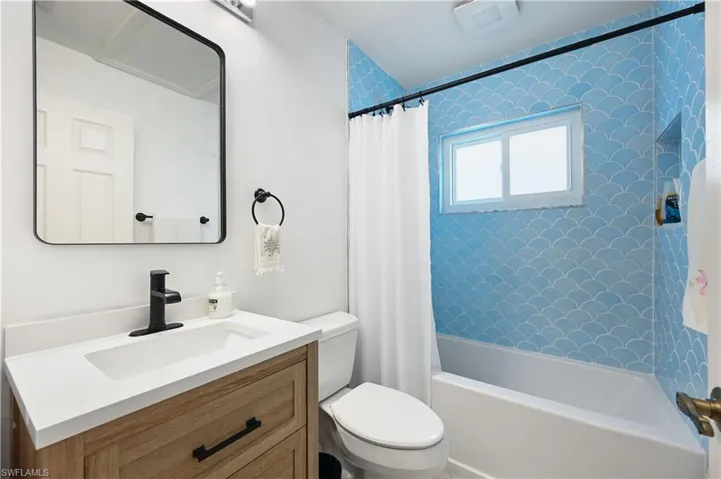 2nd Full bathroom featuring shower / bath combo and vanity