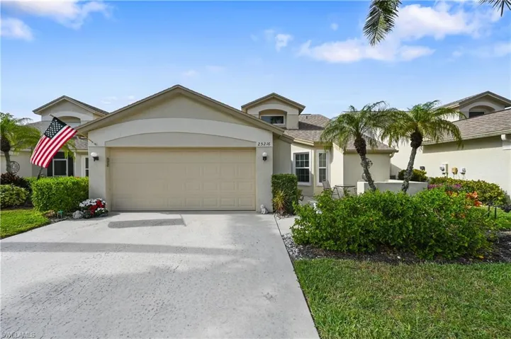 View of front of house featuring stucco siding, an attached garage, and concrete driveway