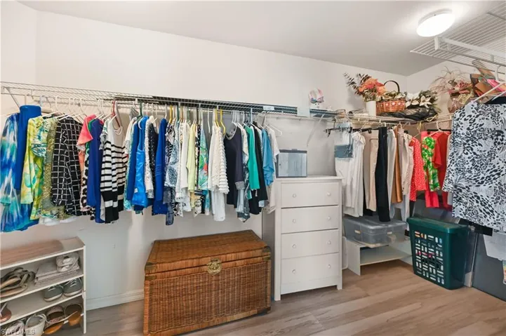 Spacious walk-in closet with wood finished floors