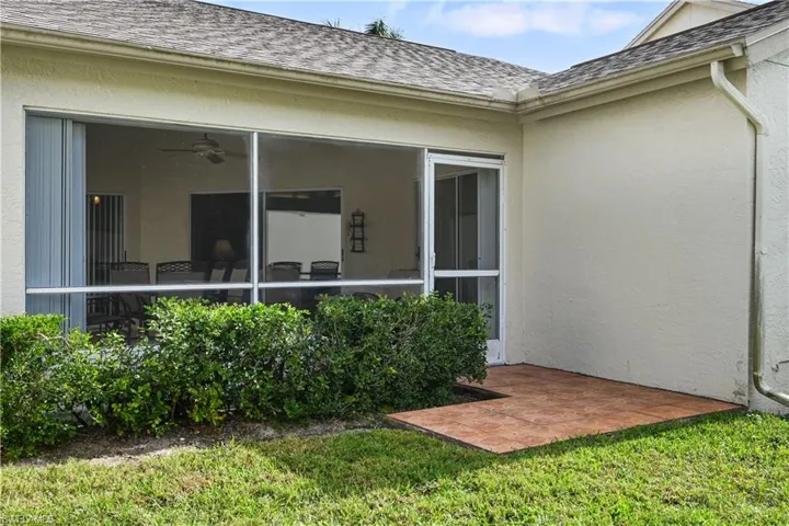 Back of property featuring a tile pad perfert for BBQ grill.
