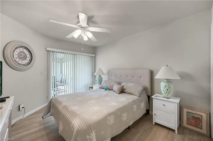 3rd Bedroom with access to exterior, light wood-type flooring, and a ceiling fan