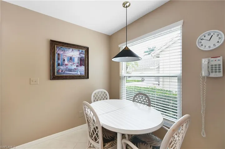 Dining space featuring light tile patterned flooring and baseboards