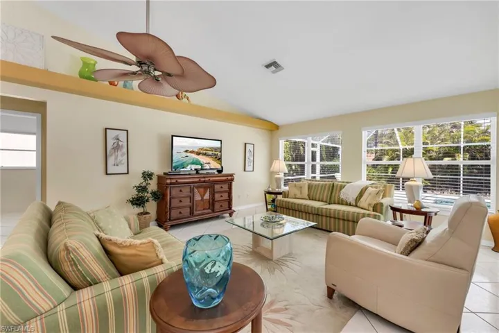 Relax in this comfortable gathering space with direct views of the lanai and pool area.