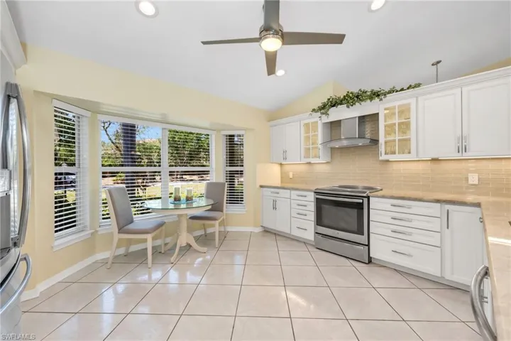 A culinary dream with sleek appliances, breakfast bar seating, and plenty of prep space.