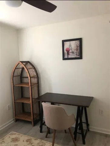 Home office featuring ceiling fan and wood-type flooring