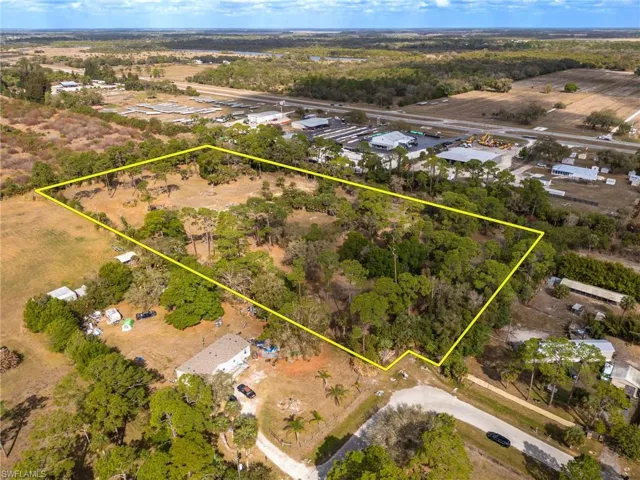 Aerial view of property and surrounding area featuring property boundaries highlighted