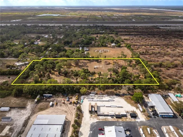 Aerial view of property and surrounding area featuring property boundaries highlighted
