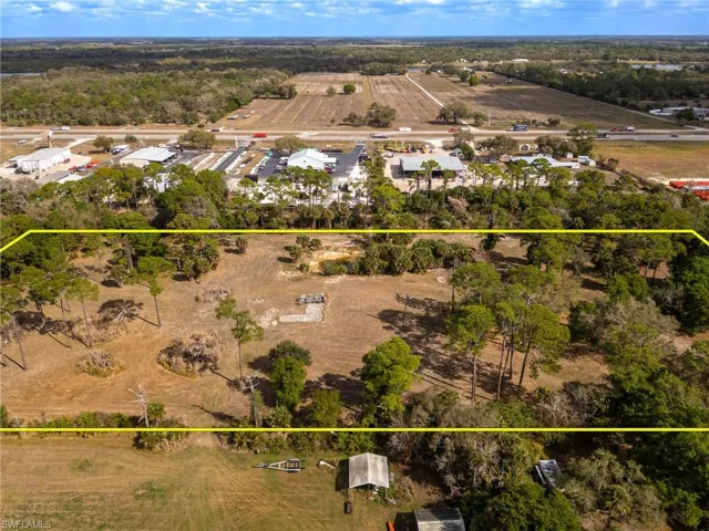 Aerial view of sparsely populated area featuring property boundaries highlighted