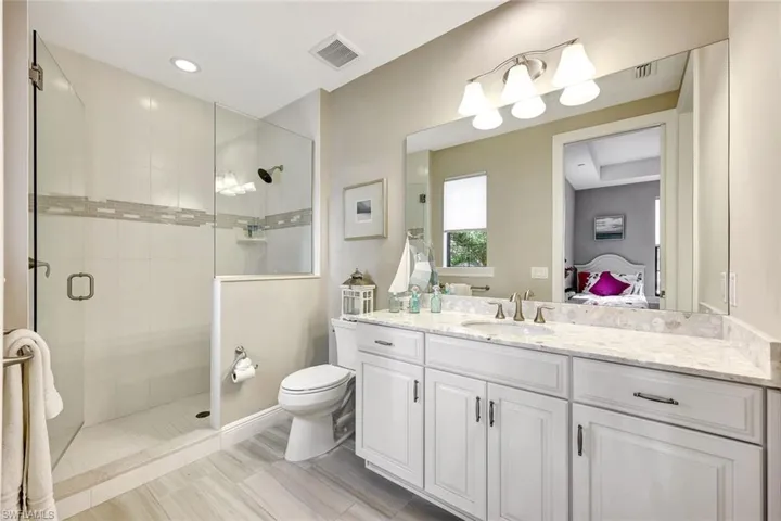 Bathroom with vanity, toilet, and walk in shower