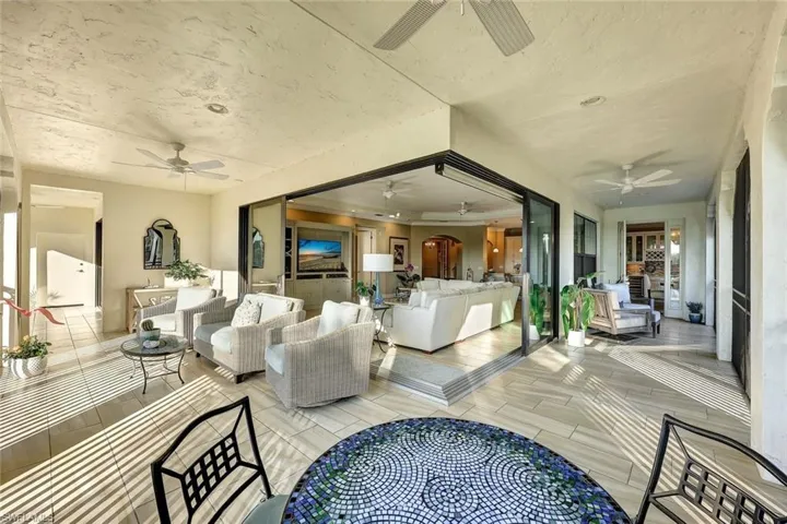 Living room with light hardwood / wood-style floors and ceiling fan