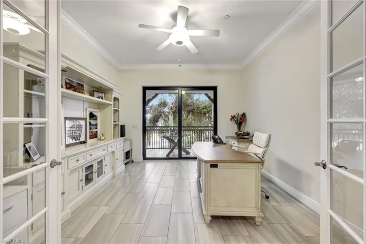Office space with ceiling fan, crown molding, and french doors