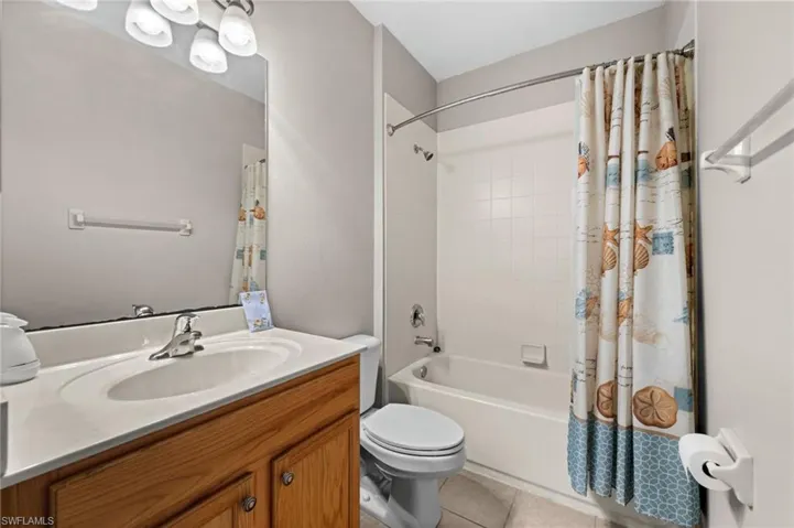 Vanity with a built-in sink, wood-finish cabinetry, and a chrome faucet
