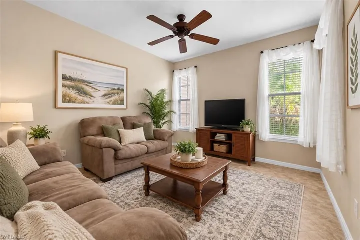 Recessed lighting, ceiling fan, two windows with blinds, and light-toned wall paint