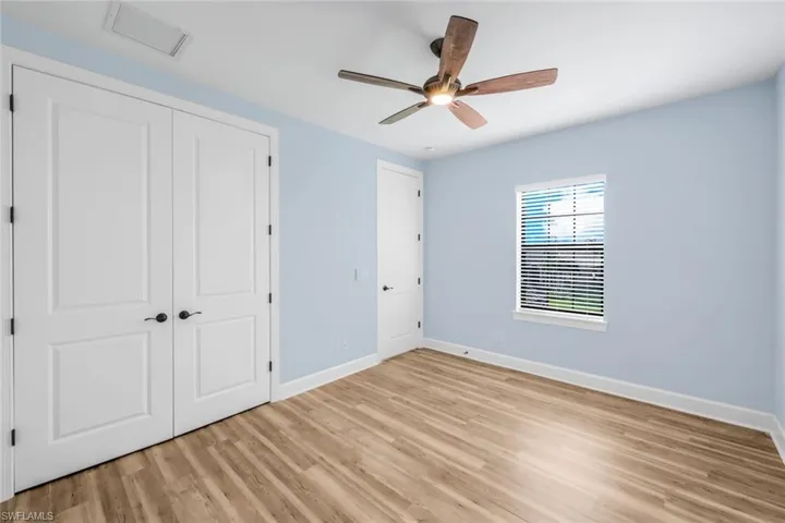 LARGE UPSTAIRS bedroom with light hardwood / wood-style flooring, a closet, and ceiling fan