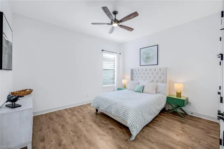 DOWN STAIRS Bedroom featuring ceiling fan and light wood-type flooring