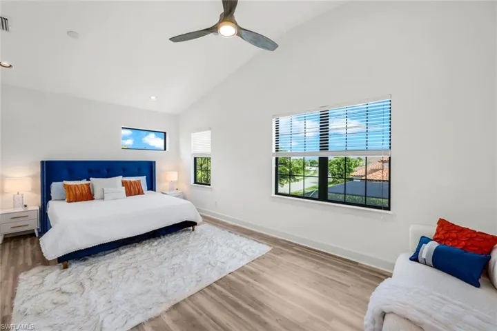 EXTRA LARGE UPSTAIRS WITH LARGE WALK IN CLOSET Bedroom featuring high vaulted ceiling, ceiling fan, and light hardwood / wood-style floors