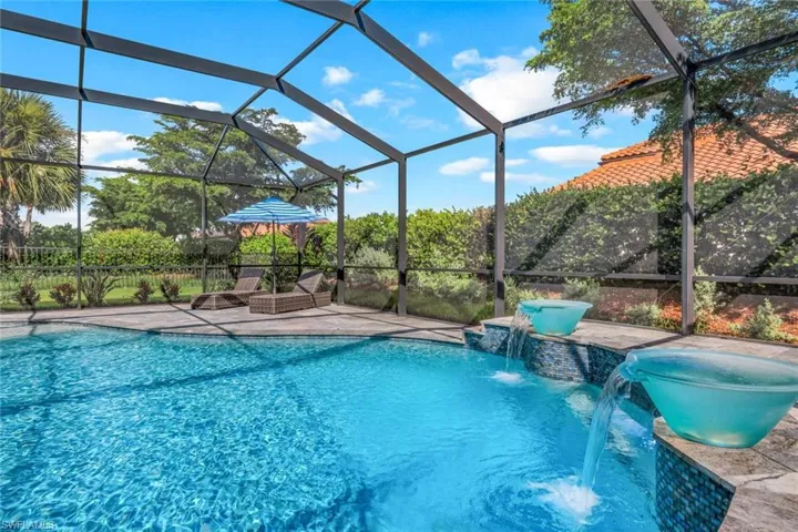 View of swimming pool with a patio, pool water feature, and a lanai