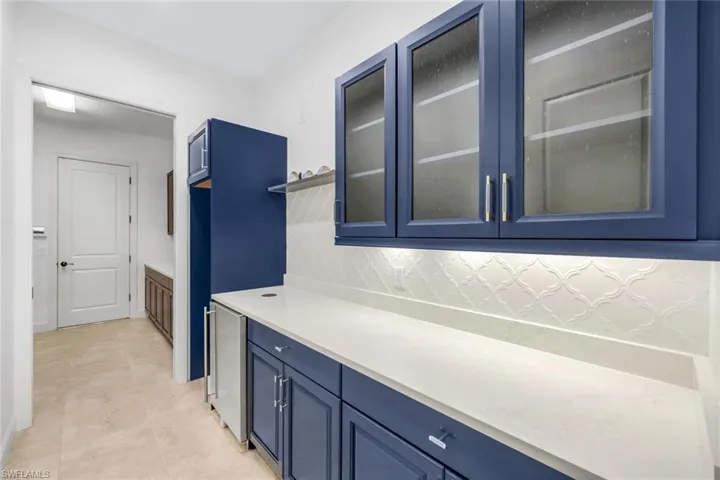 LARGE WINE COOLER COMING OVER FLOW PANTRY